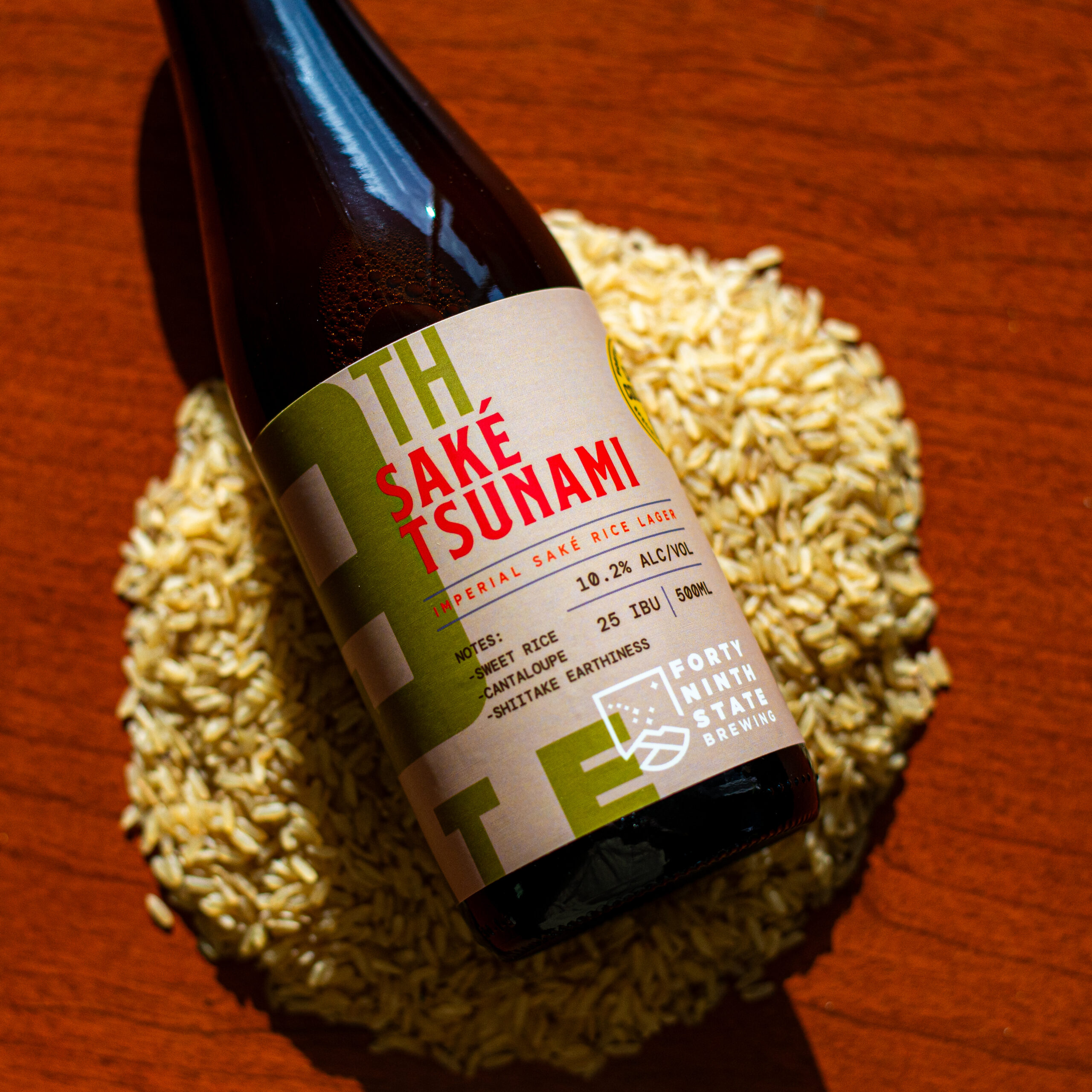 A bottle of sake beer laying on top of rice